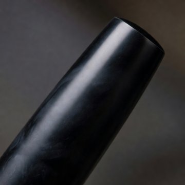Close detail of a dark ebonite fountain pen cap and its softly polished surface
