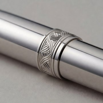 Polished metal fountain pen trim with engraved detail at the cap band
