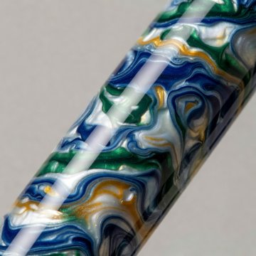 Polished patterned resin fountain pen barrel reflecting a soft strip of light